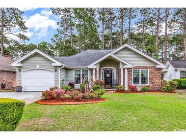 Charming single-story home featuring a manicured lawn, brick accents, and a well-maintained garden at 4738 Southern Trail, Myrtle Beach, SC 29579