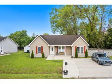 Charming single-story home with a well-manicured lawn and cozy front porch at 503 Alston St., Conway, SC 29527