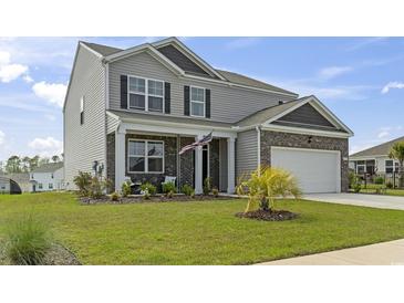 Charming two-story home with a well-manicured lawn, a brick and gray siding facade and welcoming front porch at 7037 Grant St., Little River, SC 29566
