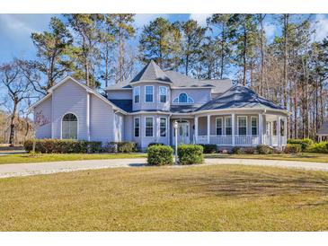 Charming home featuring manicured landscaping and a welcoming wrap-around porch at 901 Bear Lake Dr., Longs, SC 29568