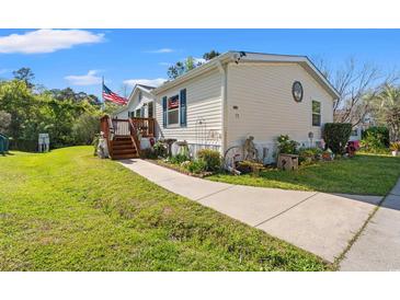 Charming single-story home featuring a quaint front porch and well-maintained lawn at 499 Folly Estates Dr., Myrtle Beach, SC 29588