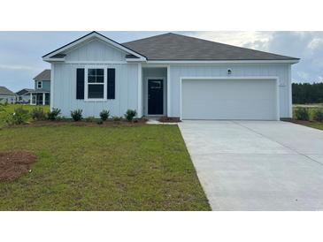 Charming single-story home featuring board and batten siding, a two-car garage, and a well-manicured lawn at 5175 Yellowstone Dr., Conway, SC 29526