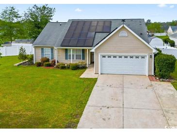 Charming single-story home featuring a well-manicured lawn and solar panels for energy efficiency at 601 Seth Ln., Longs, SC 29568