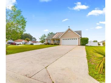 Charming single-story home with a well-manicured lawn and inviting curb appeal with attached garage at 601 Seth Ln., Longs, SC 29568