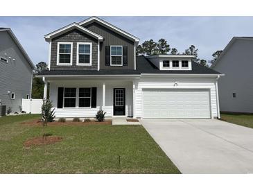 Charming two-story home featuring a well-manicured lawn and a two-car garage at 655 Mccorkle Place, Conway, SC 29526