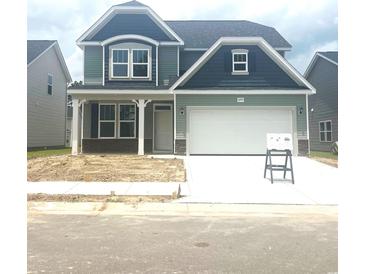 Charming two-story home with a well-manicured lawn and an attached two-car garage at 1095 Nw Forest Bend Dr., Calabash, NC 28467