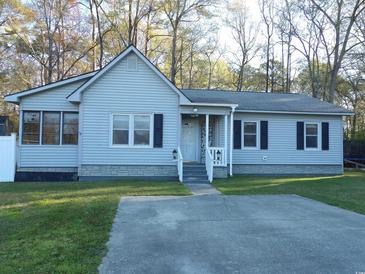 Charming single story home featuring a covered front porch and driveway at 1208 Mackie Circle, Myrtle Beach, SC 29579