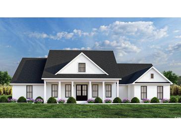 Charming new construction home with black framed windows, a covered porch, and a well-manicured front yard at 1464 Hawthorn Dr., Pawleys Island, SC 29585