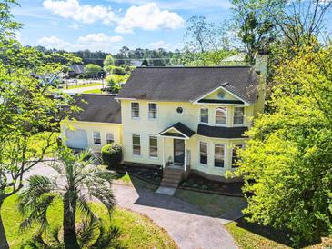 Charming two-story home with a well-manicured yard, inviting curb appeal, and a lovely palm tree at 205 Lander Dr., Conway, SC 29526