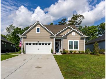 Charming single-story home featuring a two-car garage and well-manicured lawn at 402 Bumble Circle, Murrells Inlet, SC 29576