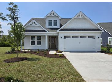 Charming single-Gathering home with a two-car garage, manicured lawn, and beautiful landscaping at 708 Lapwind Loop, Myrtle Beach, SC 29579