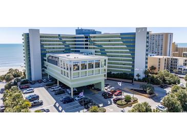 Oceanfront condo building featuring a parking garage and beach access at 1105 S Ocean Blvd. # 422, Myrtle Beach, SC 29577