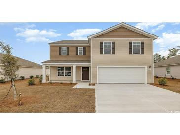 Charming two-story home with a neutral color scheme, a front porch, and an attached two-car garage at 1447 Nokota Dr., Conway, SC 29526