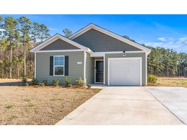 Charming one-story home featuring a one-car garage, neutral siding, and manicured landscaping at 154 Seasons Trace Loop, Longs, SC 29568