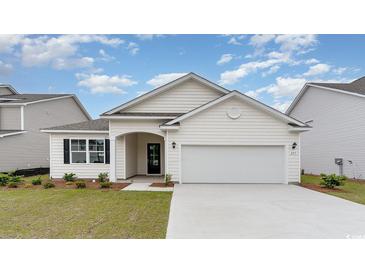 Charming single-story home featuring a two-car garage, arched entryway, and well-manicured lawn at 1804 Hardwood Ct., Conway, SC 29526