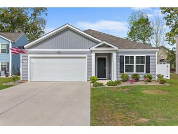 Charming one-story home with an attached garage, gray siding, and well-maintained landscaping at 234 Belmonte Dr., Myrtle Beach, SC 29588