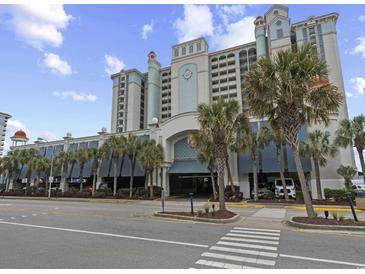 Attractive multi-story building, with palm trees, covered parking and beach access at 2401 S Ocean Blvd. S # 1256, Myrtle Beach, SC 29577