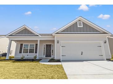 Charming single-story home with a two-car garage, well-maintained lawn, and inviting entryway at 3336 Little Bay Dr., Conway, SC 29526