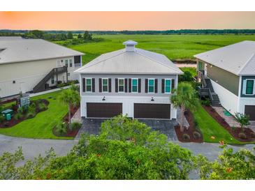 Beautiful two-story home with a two-car garage and a stunning view of the marsh at 35 Red Skiff Ln. # 35, Pawleys Island, SC 29585