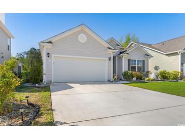 Charming single-story home with a well-manicured lawn, a two-car garage, and a lovely front yard at 363 Cypress Springs Way, Little River, SC 29566