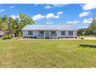 Charming one-story home with a large front yard and a quaint, covered front porch at 5086 Highway 319 E, Conway, SC 29526