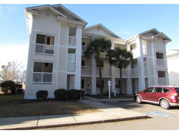 Inviting condo building featuring multiple floors, private balconies, and well-maintained landscaping at 573 Blue River Ct. # 8-H, Myrtle Beach, SC 29579