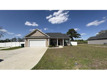 Charming single-story home with attached garage, complemented by a well-manicured lawn and lovely landscaping at 6392 Highway 378, Conway, SC 29527