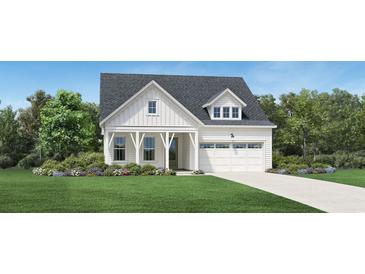 Charming two-story home featuring a welcoming front porch and attached two car garage at 6709 Genesis Dr, Murrells Inlet, SC 29576
