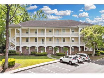 Inviting condo exterior features balconies, manicured lawn, and ample parking at 679 Riverwalk Dr. # 201, Myrtle Beach, SC 29579