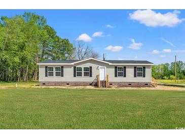 Charming single-story home with gray siding, black shutters, and a well-maintained lawn at 820 S Midway Hwy., Johnsonville, SC 29555