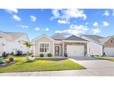 Charming single-story home with a well-manicured lawn and a one-car garage in a quiet neighborhood at 1239 Pyxie Moss Dr., Little River, SC 29566