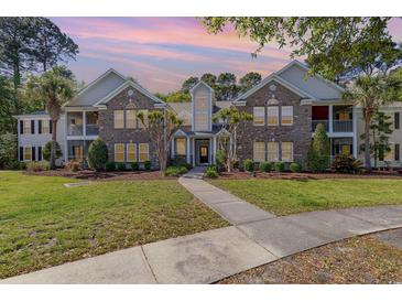 Beautiful two-story condo with well-manicured lawn, brick facade, and inviting walkway at 19 Pistachio Loop # G, Murrells Inlet, SC 29576