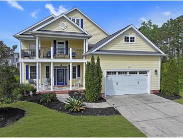 Charming two-story home featuring a porch, balcony, manicured lawn, and a two-car garage at 4017 Chalmers Ct., Myrtle Beach, SC 29579