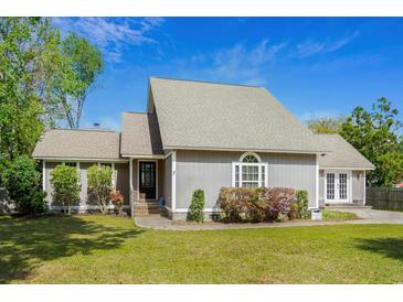 Charming home featuring a well-manicured lawn, welcoming front entrance, and beautiful landscaping at 7 Pine Valley Ln., Surfside Beach, SC 29575