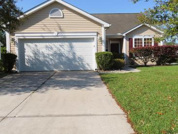 Charming single-story home with attached garage, mature landscaping, and inviting curb appeal at 819 Brookline Dr., Myrtle Beach, SC 29579