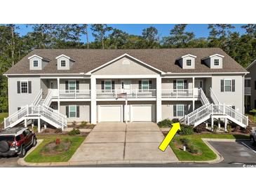 Charming townhouse with gray siding, white trim, a two-car garage, and a welcoming staircase to the entrance at 932 Jackline Place # 103, Murrells Inlet, SC 29576