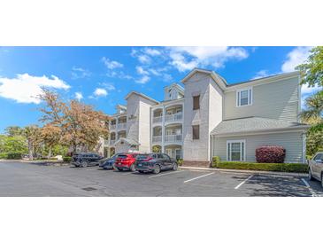Attractive multi-story condominium building with ample parking and well-maintained landscaping at 1033 World Tour Blvd. # 203, Myrtle Beach, SC 29579