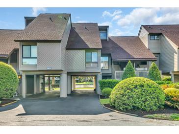 Charming condo featuring covered parking and lush landscaping with a glimpse of the tranquil waters beyond at 112 Spartina Ct. # 26, Pawleys Island, SC 29585