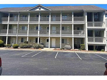 Three-story condo building with white doors, windows, and railings, offering a charming coastal living experience at 1450 Blue Tree Ct. # I, Myrtle Beach, SC 29588