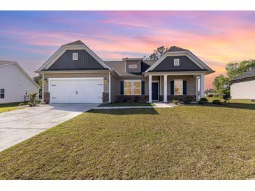 Charming single-Gathering home with a two-car garage and well-manicured lawn under a colorful sky at 204 Palmetto Sand Loop, Conway, SC 29527