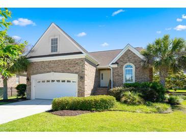Charming brick home with well-manicured lawn and attached two-car garage under a bright blue sky at 2213 Gazebo Ct., North Myrtle Beach, SC 29582