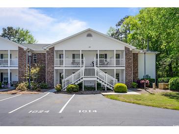 Inviting condo with brick accents, white stairs, and balconies at 245 Egret Run Ln. # 1023, Pawleys Island, SC 29585