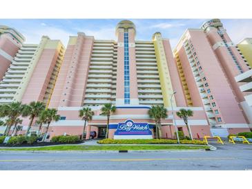 Multi-story beachfront resort with pale pink siding, multiple balconies and mature palm trees in manicured landscaping at 2711 Ocean Blvd. S # 915, North Myrtle Beach, SC 29582