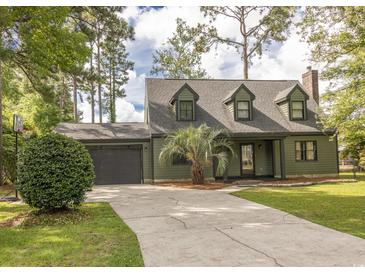 Charming two-story home with dormer windows, a spacious driveway, and attached garage at 302 St. Andrews Ln., Myrtle Beach, SC 29588