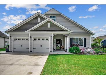Charming single Gathering home with a three-car garage and manicured lawn at 3034 Viceroy Loop, Little River, SC 29566