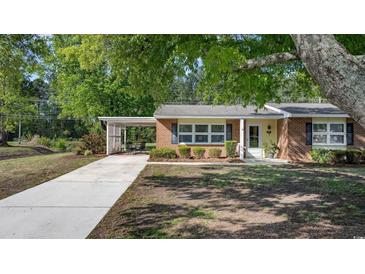 Charming single-story brick home with a covered carport and well-maintained landscaping at 3731 Spruce Dr., Myrtle Beach, SC 29577