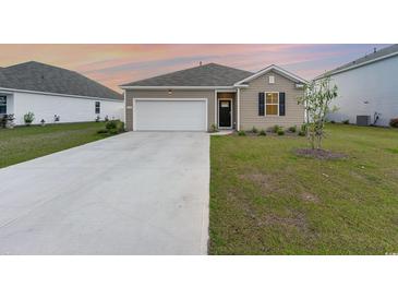 Charming single-story home with a well-manicured lawn and a spacious two-car garage at 376 Black Pearl Way, Myrtle Beach, SC 29588