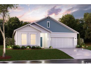 Charming single-story home with a two-car garage, beautiful landscaping, and a mix of white and blue siding at 408 Kapalua Loop, Little River, SC 29566