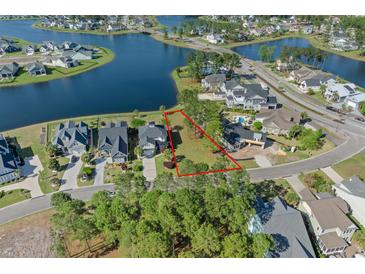 Beautiful vacant lot in a waterfront community, outlined in red, perfect for building your dream home at 573 Starlit Way, Myrtle Beach, SC 29579