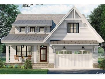 Charming two-story home featuring a metal roof, inviting front porch, and an attached two-car garage at 573 Starlit Way, Myrtle Beach, SC 29579